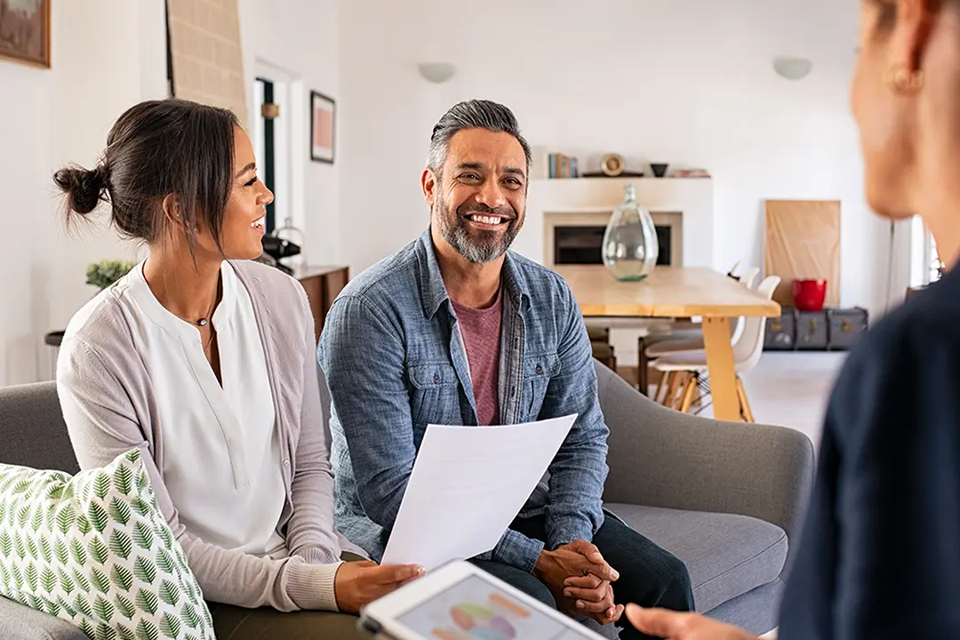 Couple talking to financial advisor at home